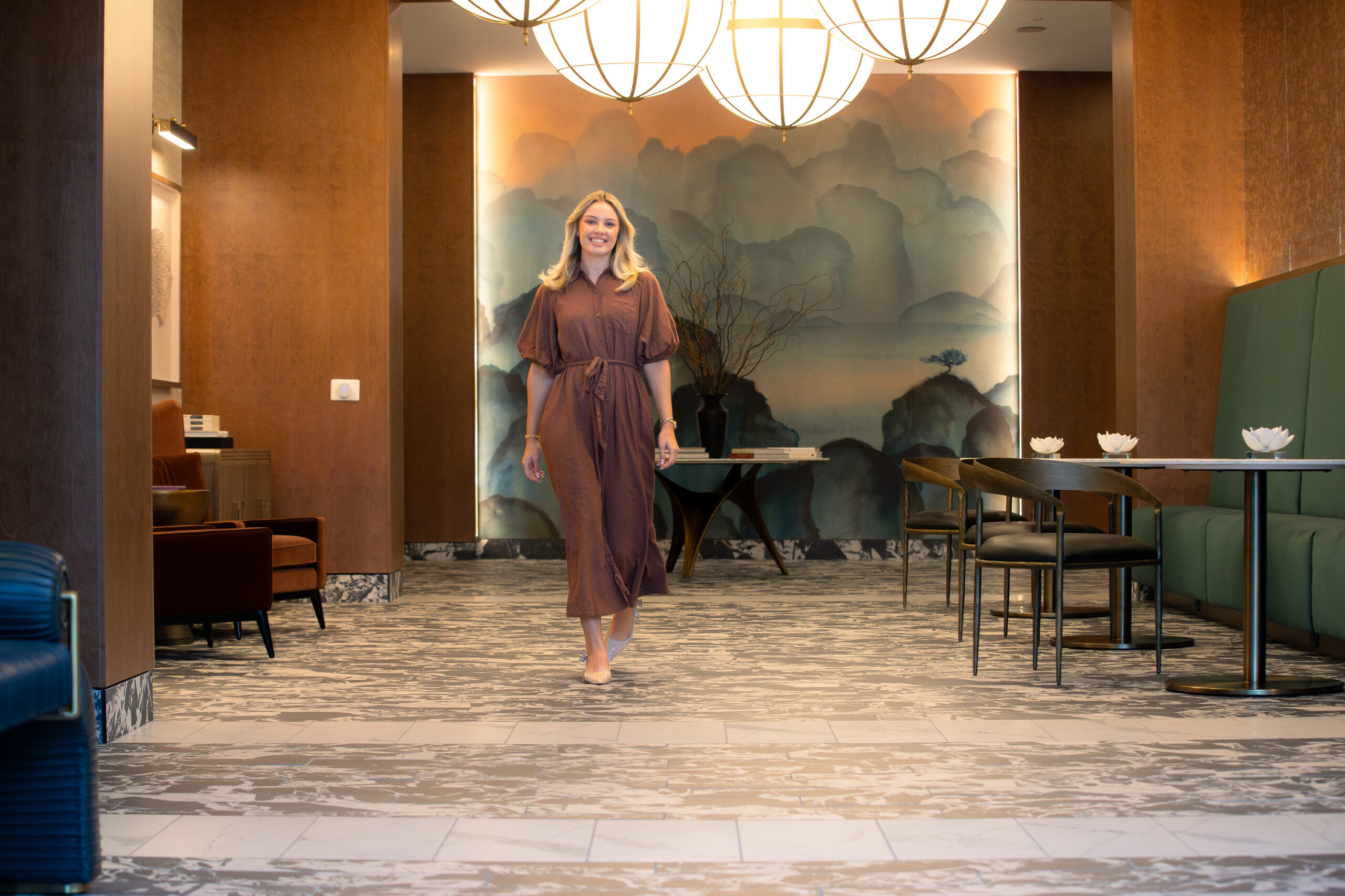 woman walking through furnished lobby
